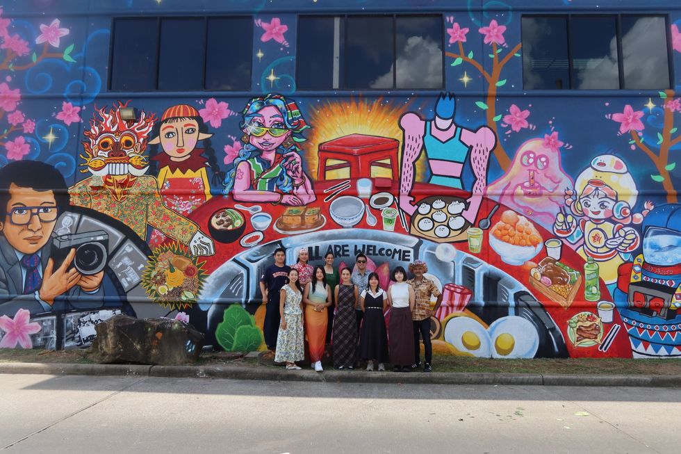 GONZO247 and the EpNex Meridian Fellows in front of the completed "Painted Bridges" mural.