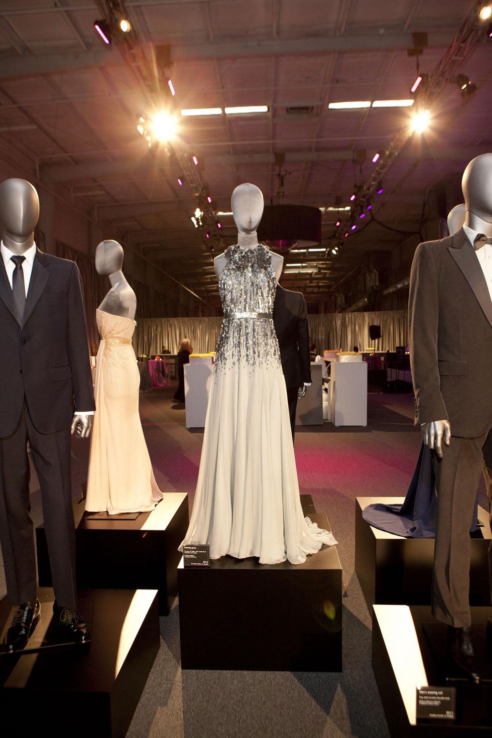 Gucci on display at the Alley Ball April 2014 silver dress designed for Mila Kunis