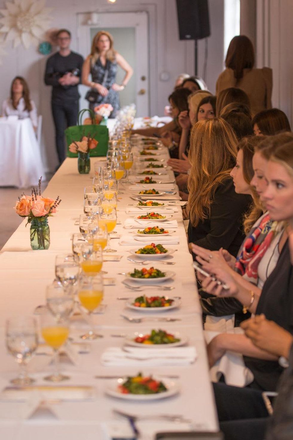 Guests at table at David Peck's first runway fashion show in new space