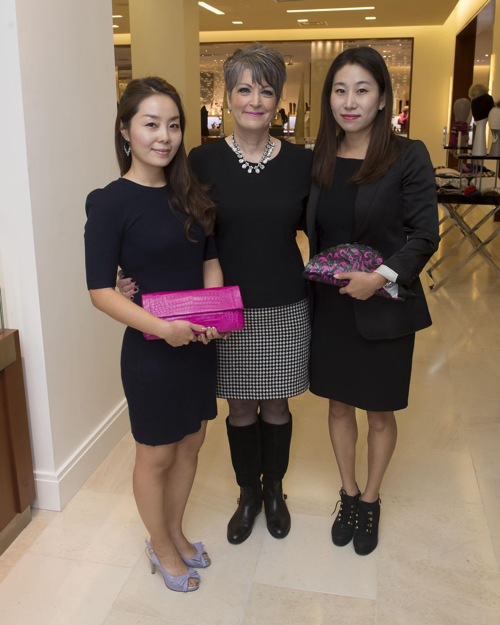Guests holding Nancy Gonzalez creations at Nancy Gonzalez at Saks Fifth Avenue November 2014