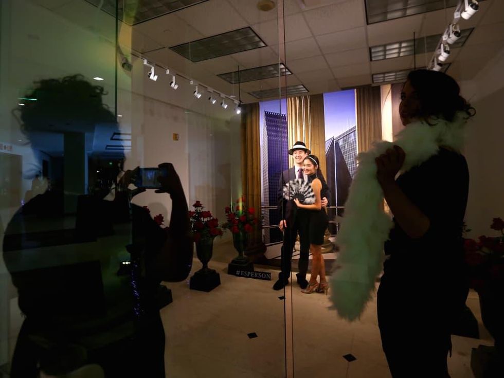 Guests play in a photo booth at the Ars Lyrica "Roaring Twenties" Gala