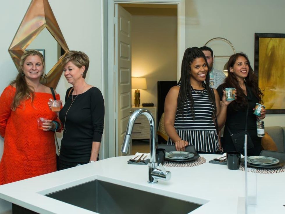 Guests tour Marq 31 apartment at CultureMap Summer Social