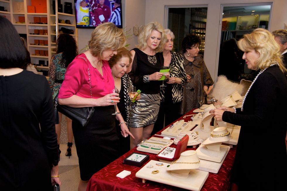 Guests viewing jewelry on sale for benefit at Theresa Roemer first charity closet party November 2014