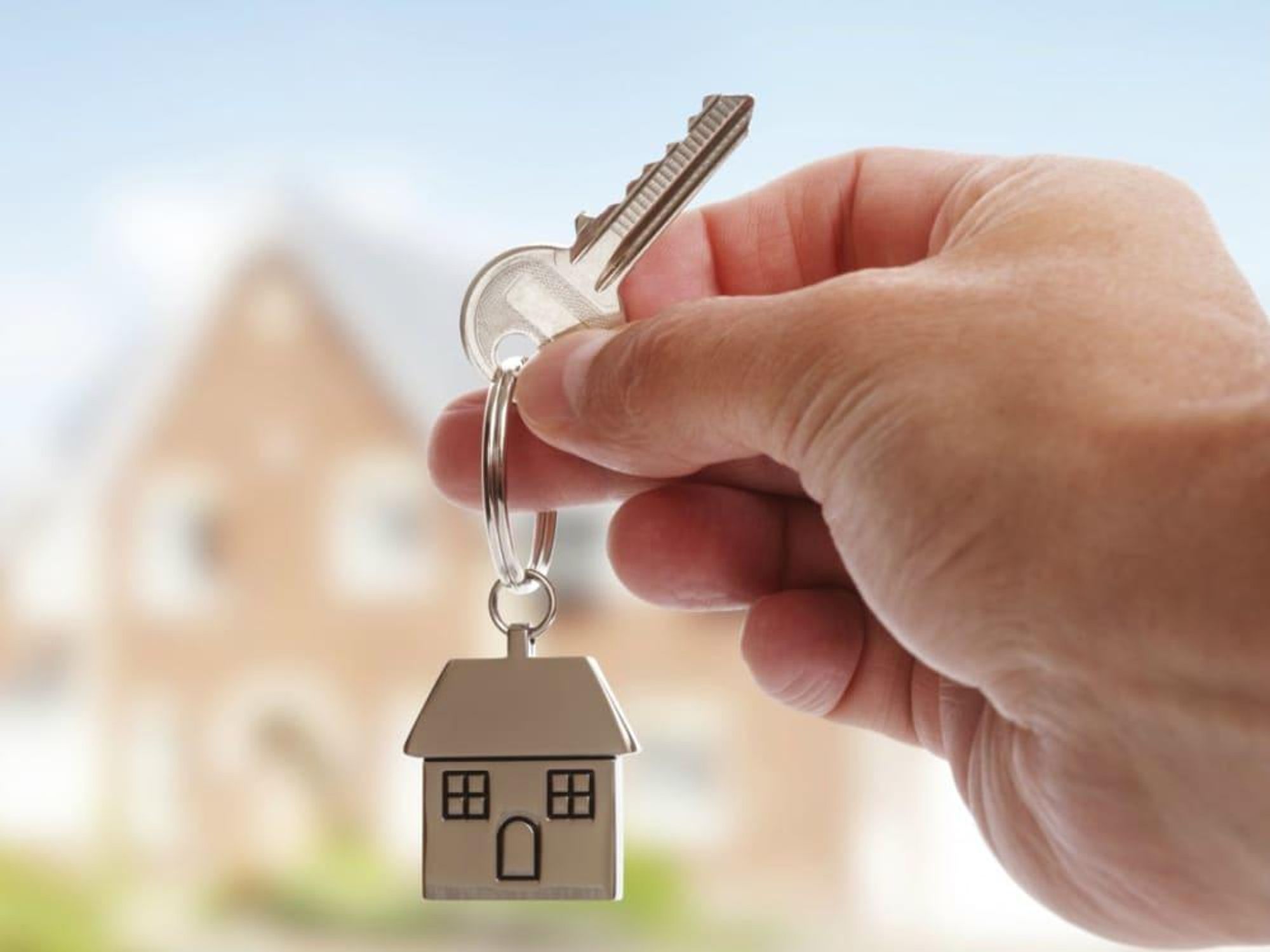 Hand holding a house key