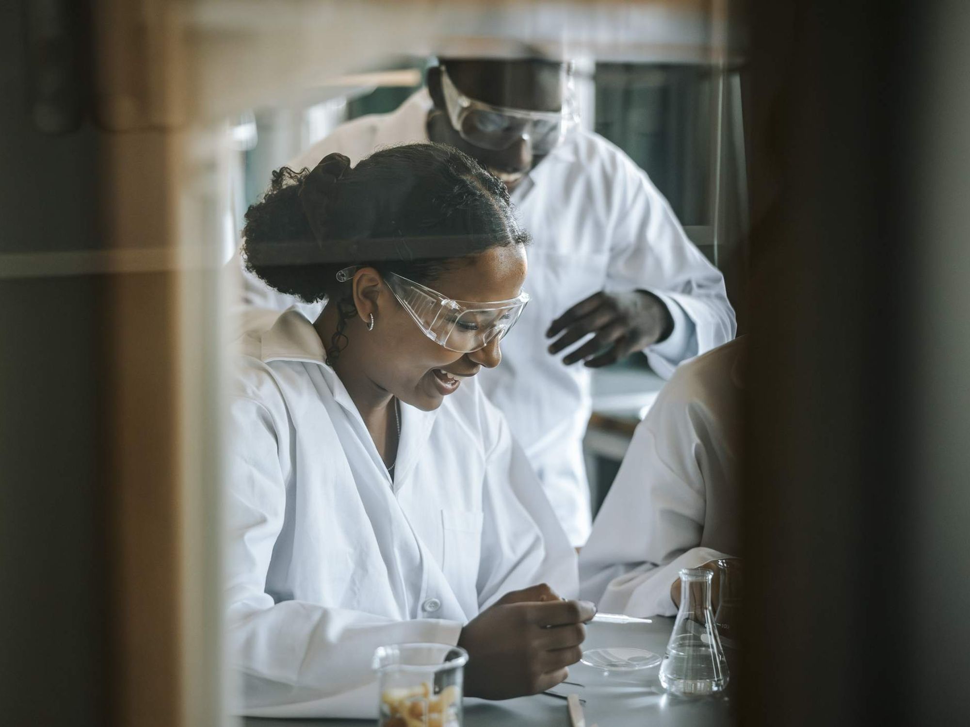 Happy students doing science experiment in laboratory