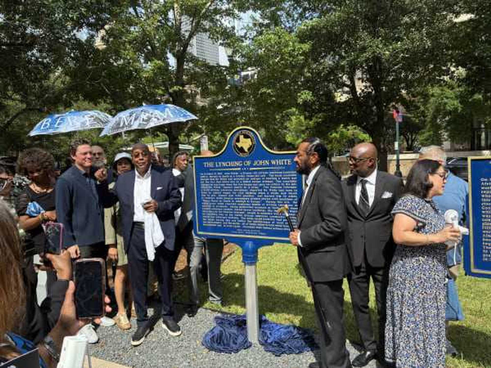 Harris County Commisioner Rodney Ellis and Rep. Al Green posing in front of new historical markers for Remembrance Park.