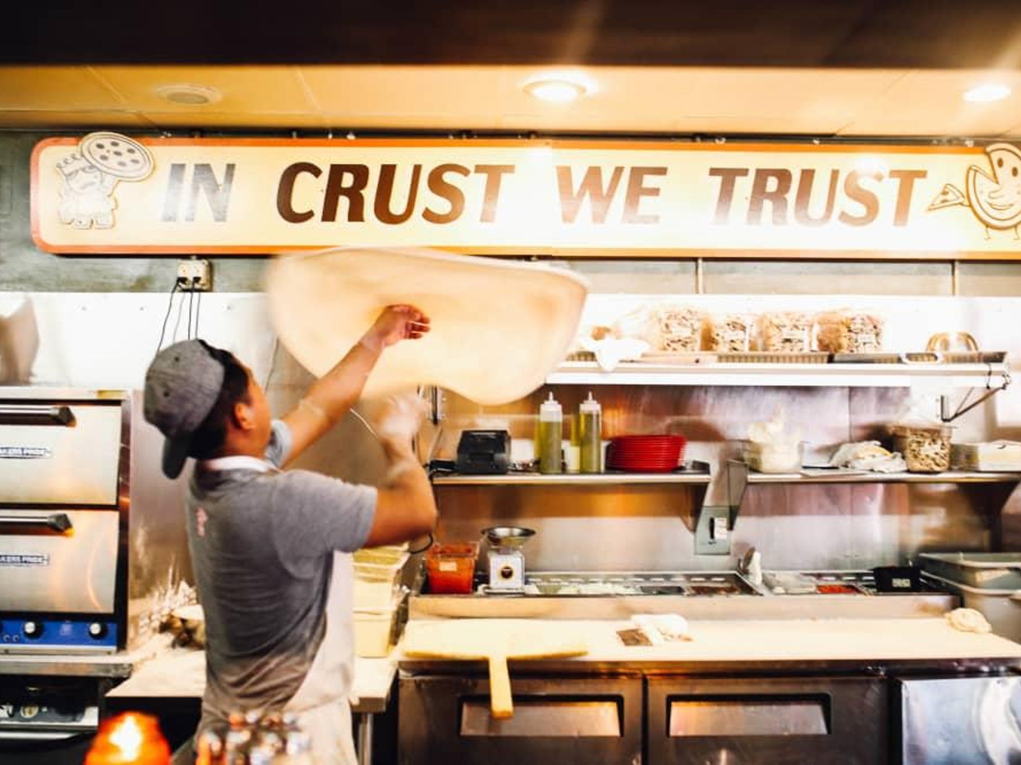 Home Slice Pizza tossing pizza