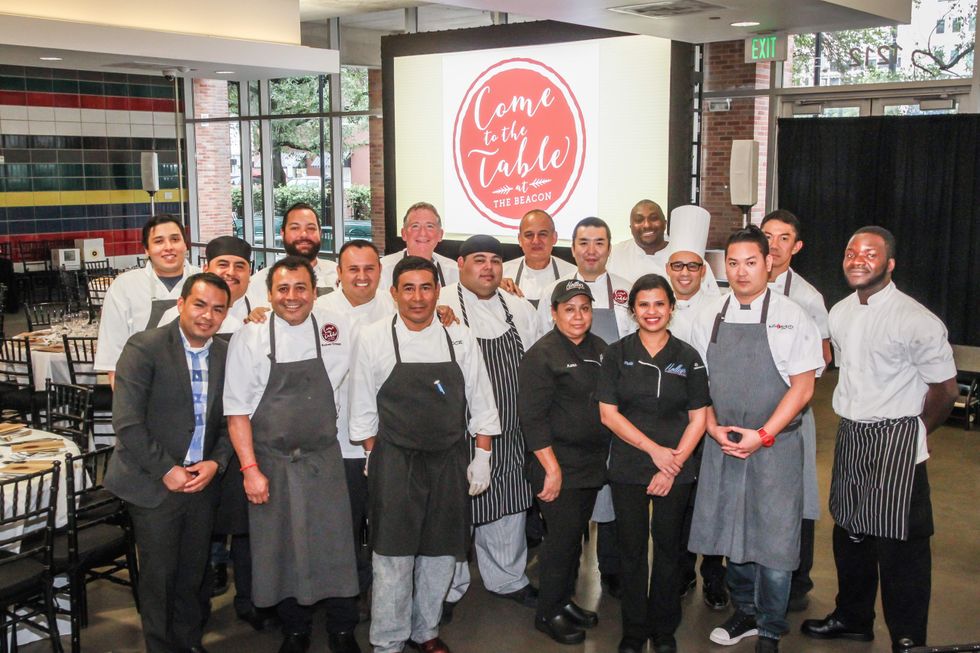 Houston chefs in front of a Come to the Table banner