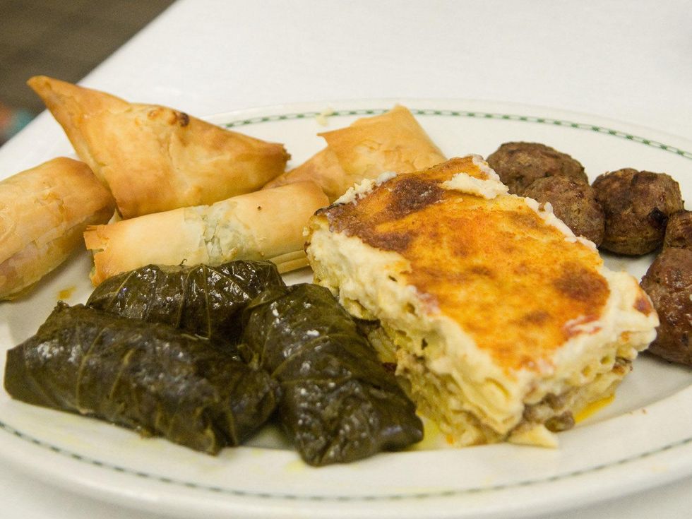 Houston Greek Festival tasting grape leaf wraps, lasagna, meatballs