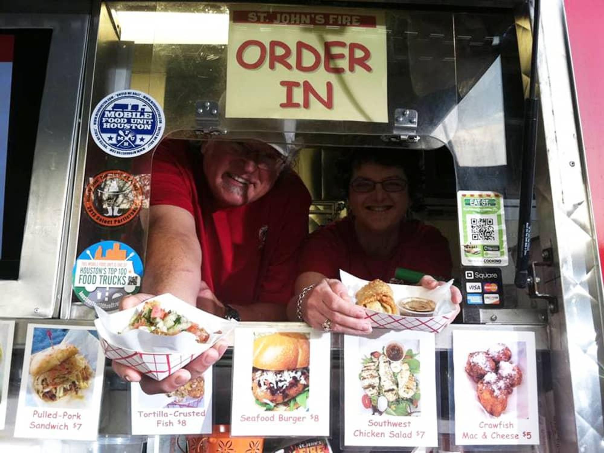 Houston Haute Wheels Food Truck Festival vendors holding out food