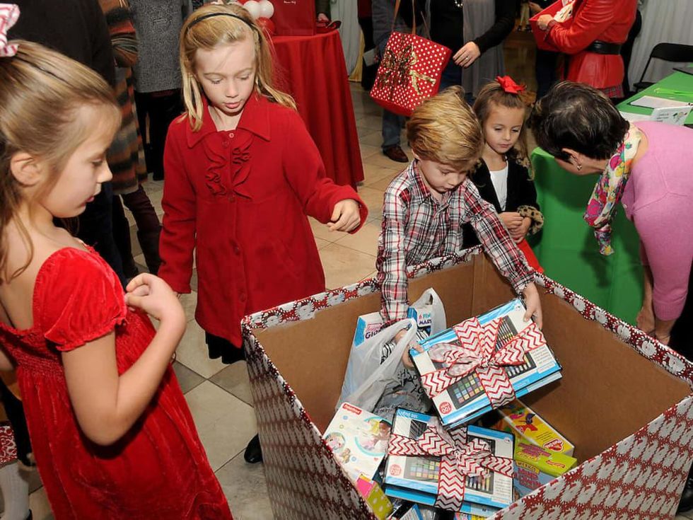 Houston, M.D. Anderson Breakfast with Santa, Dec 2016, Children donate gifts at the M.D.Anderson Breakfast with Santa