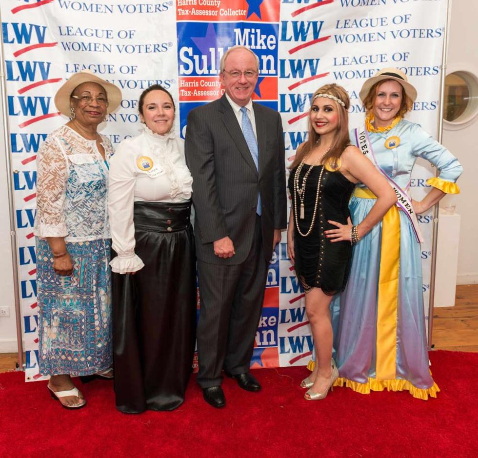 Houston's Women's Equality Day Celebration, Harris County Tax Assessor-Collector and Voter Registrar Mike Sullivan, flanked by Event Co Chairs Aimee Bertrand and Parisa Moayedi and event attendees