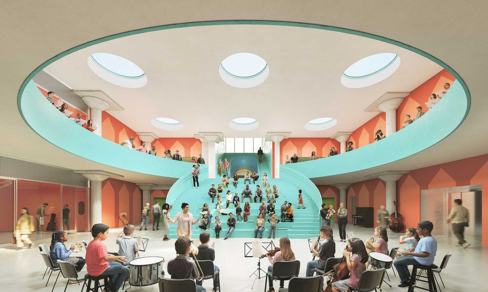 Image of a music class space in FLAMA with a stairway in the background, curving upward to show people looking over the railing and the musicians below.