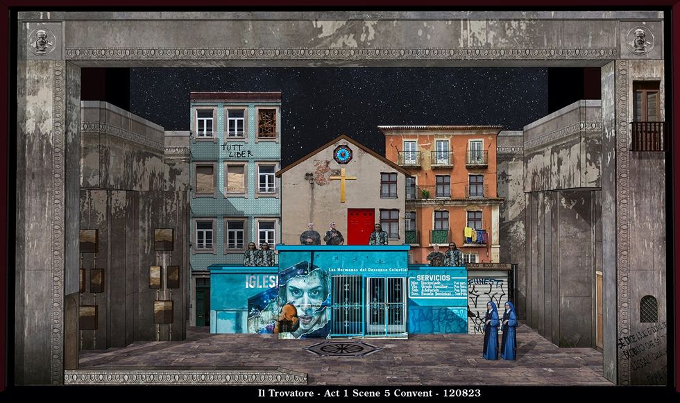 Image of the set design for Il Trovatre, showing a square in Europe surrounded by multistory, rundown houses, a shop with bars on the windows and two nuns in blue habits in the foreground.