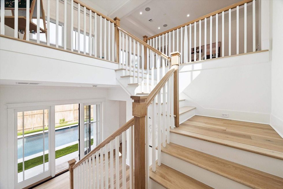 Interior staircases of 1039 Harvard Street overlooking the backyard pool