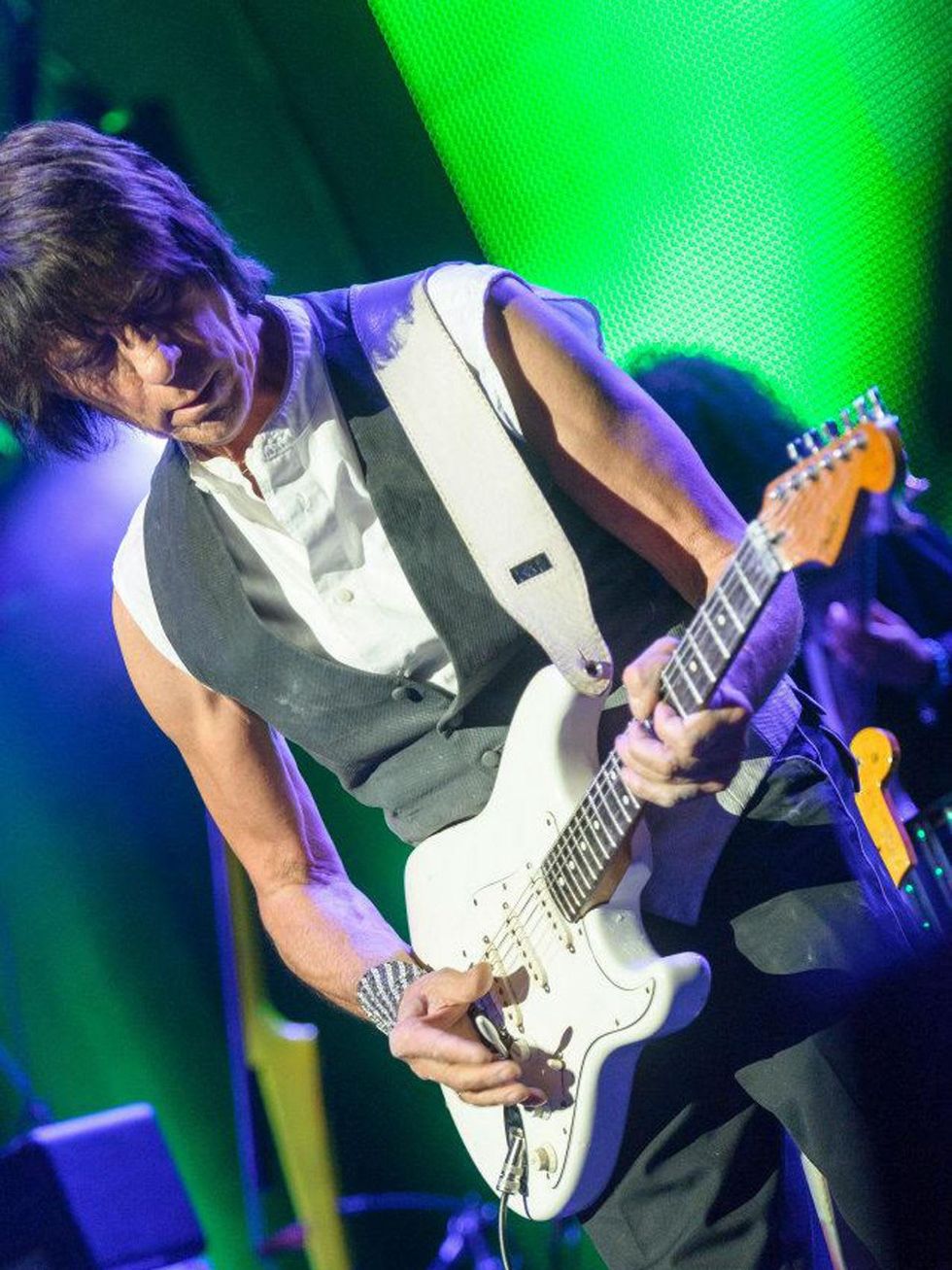 Jeff Beck playing guitar in concert