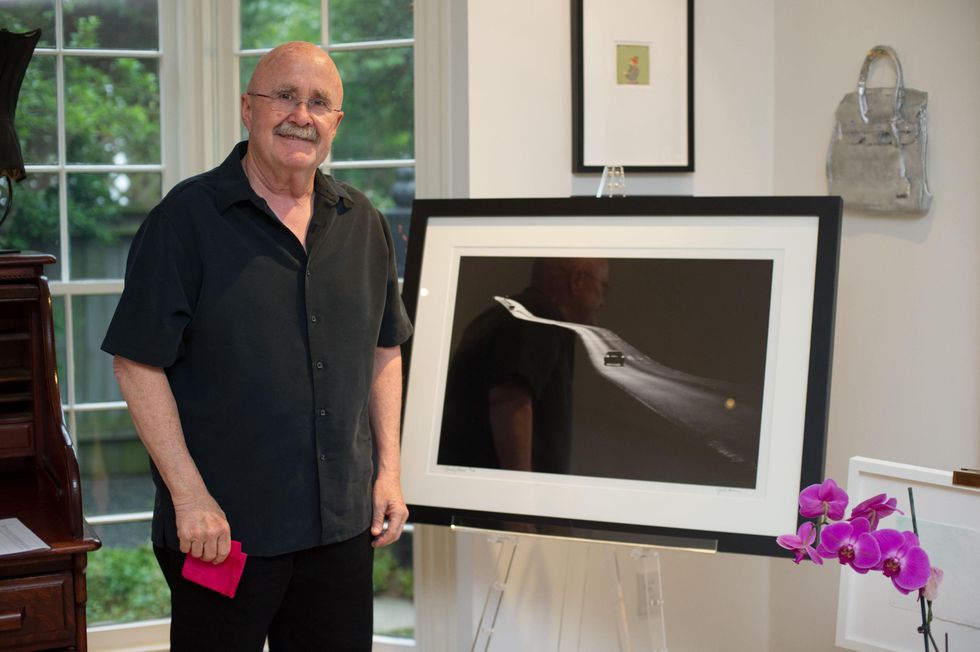 Joe Aker in front of his artwork at Planned Parenthood Fine Art Auction
