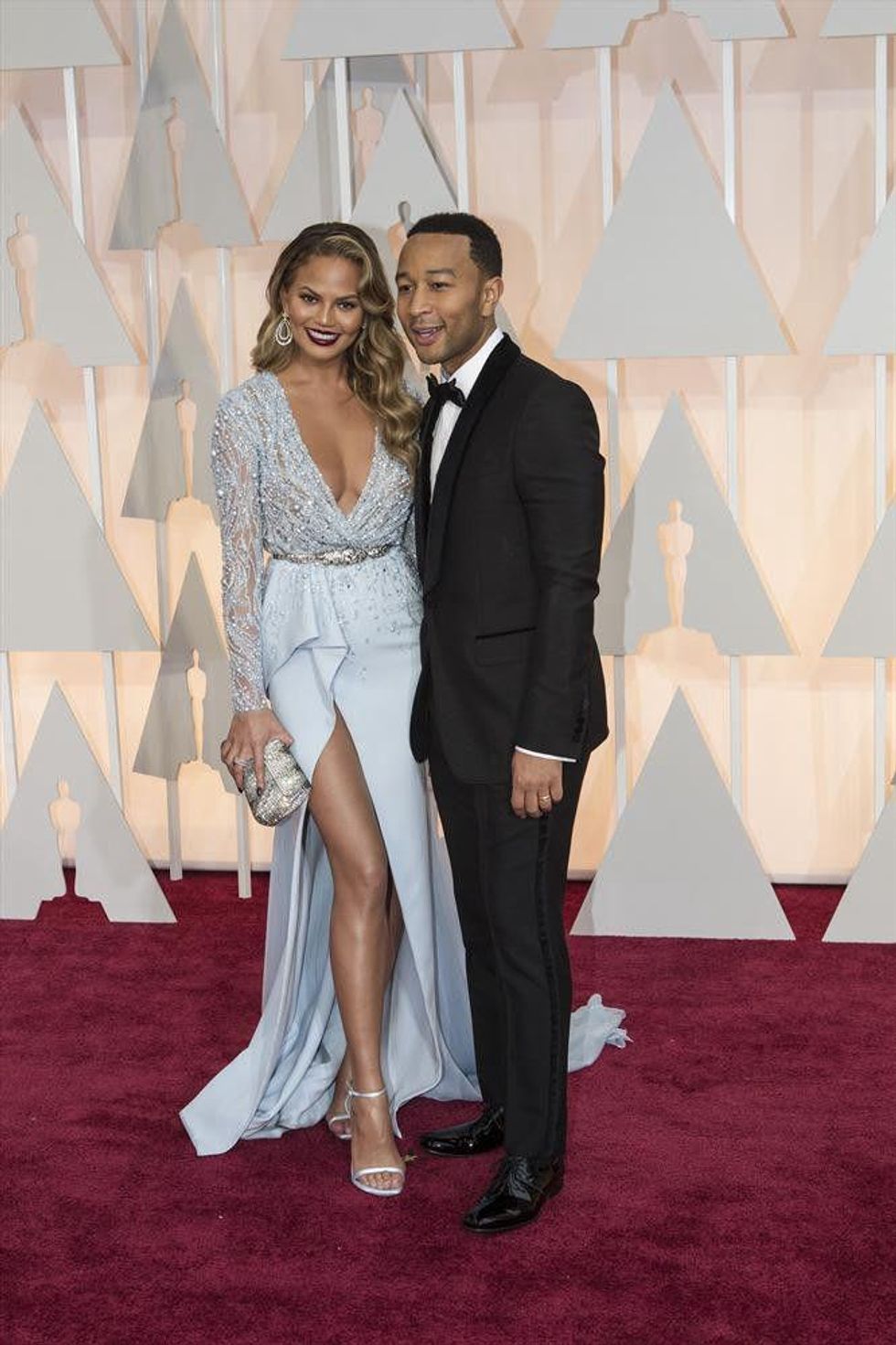 John Legend and Chrissy Teigen on red carpet at Oscars