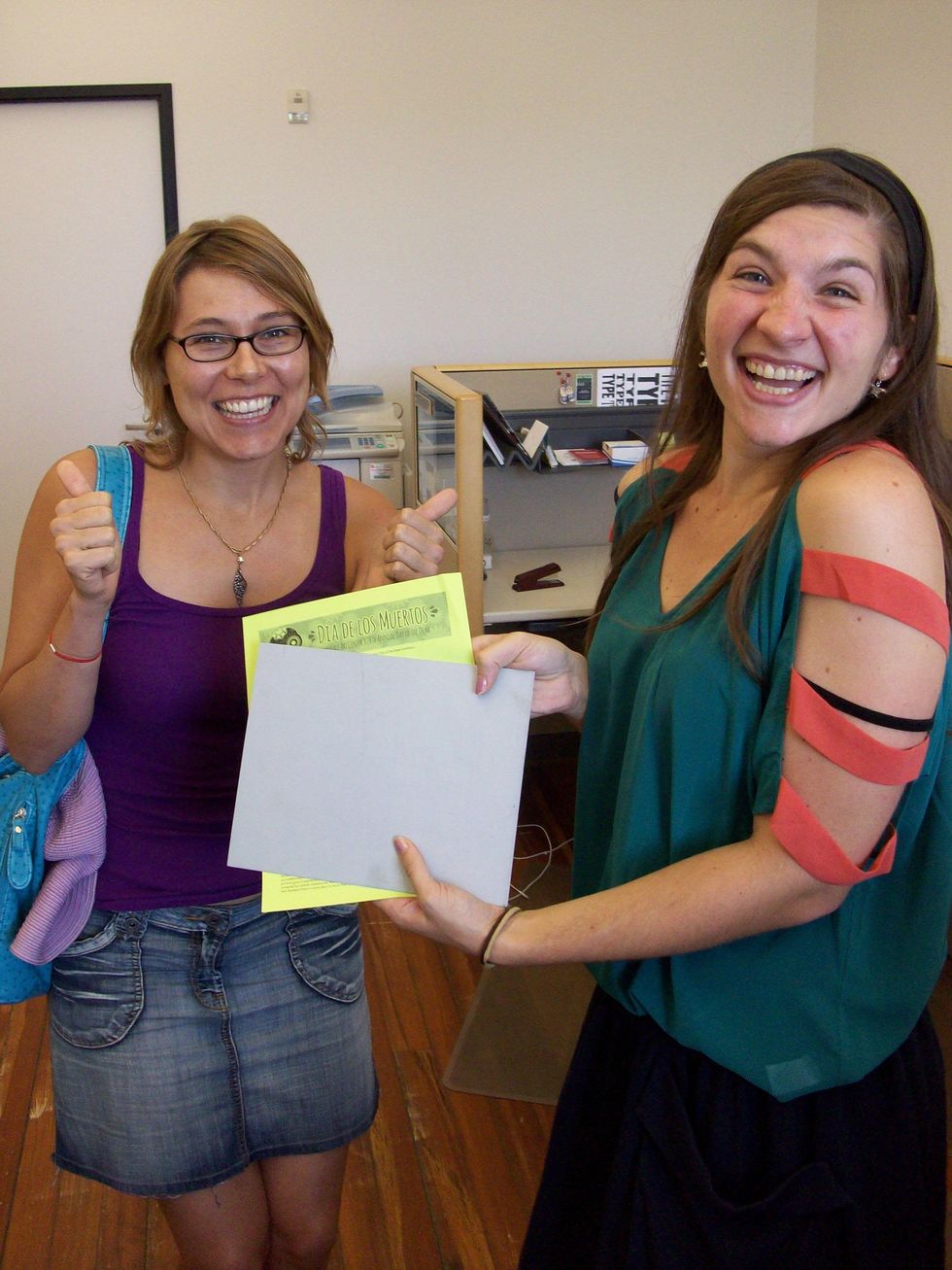 Kelly Montana, Lawndale's Office Manager, and artist Kia Neill retablo tin distribution at Lawndale Art Center August 2013