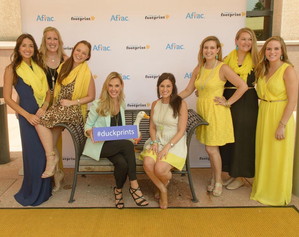 Kendra Scott in the middle and her Houston team with the Aflac Duck