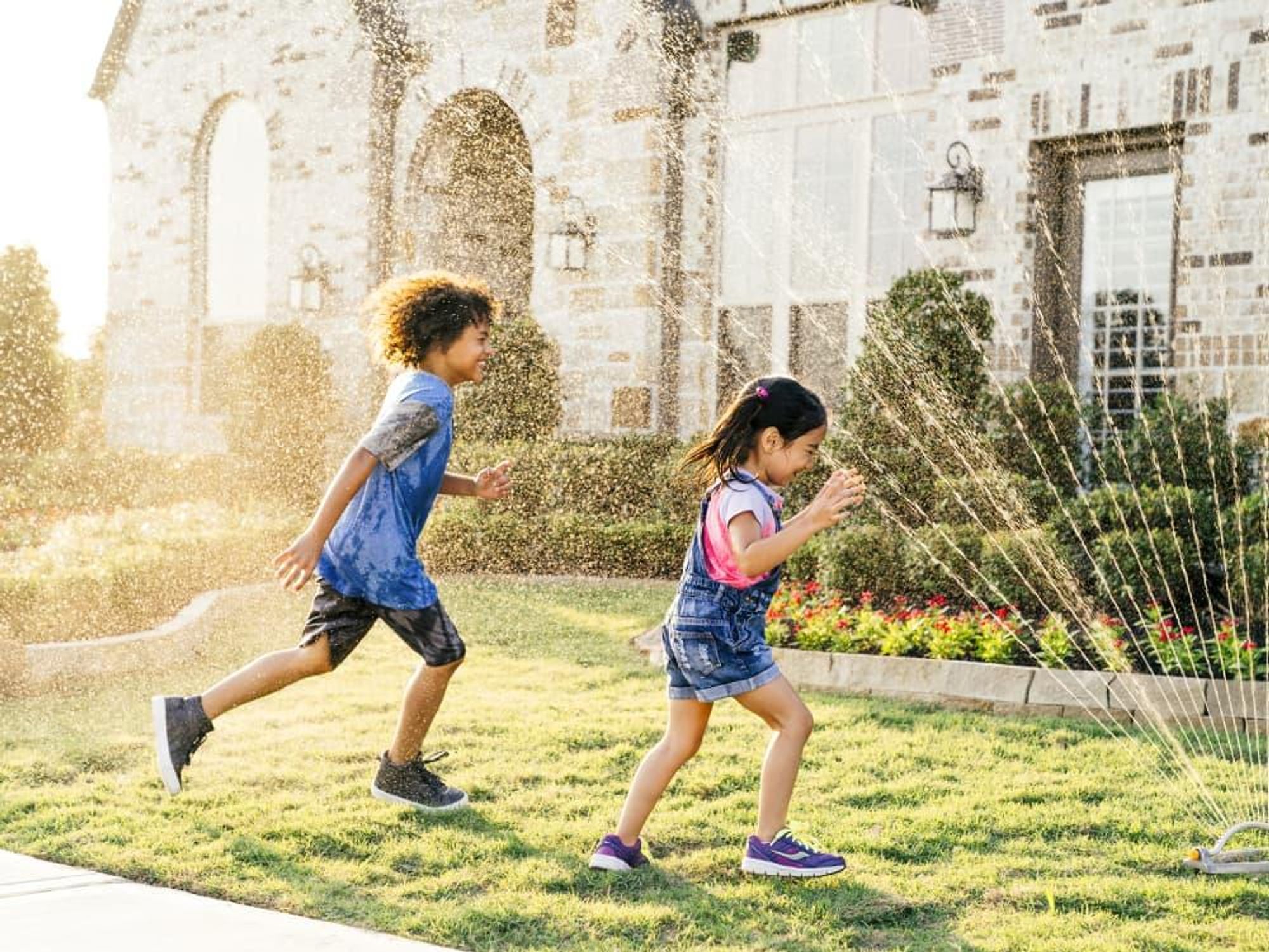 Kids playing in a sprinkler