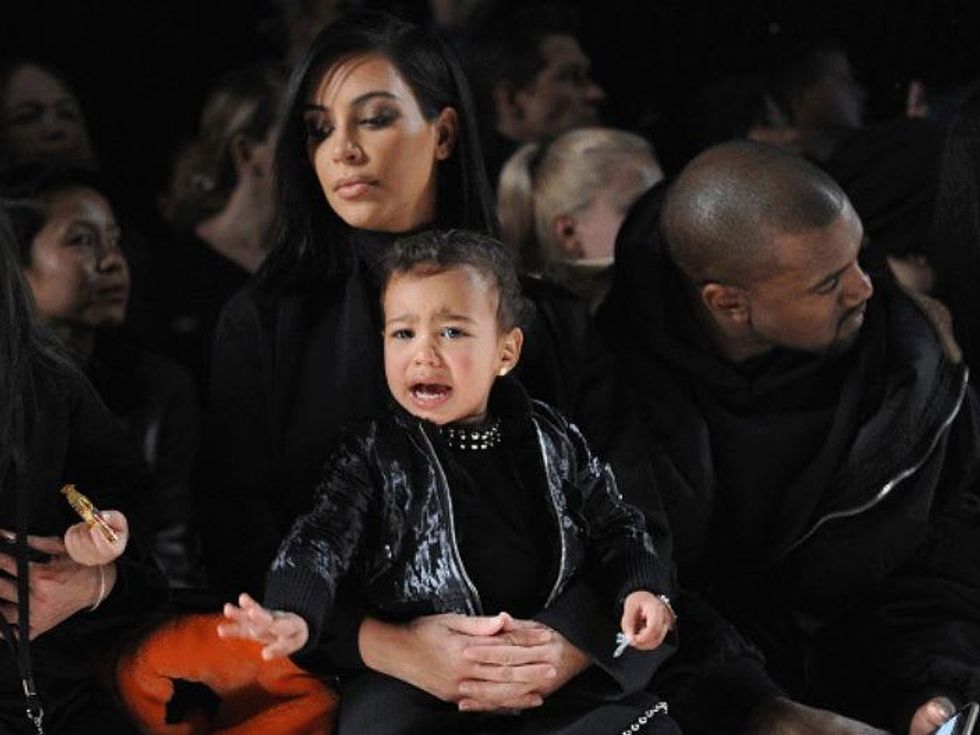 Kim Kardashian with North West crying baby at Alexander Wang fashion show