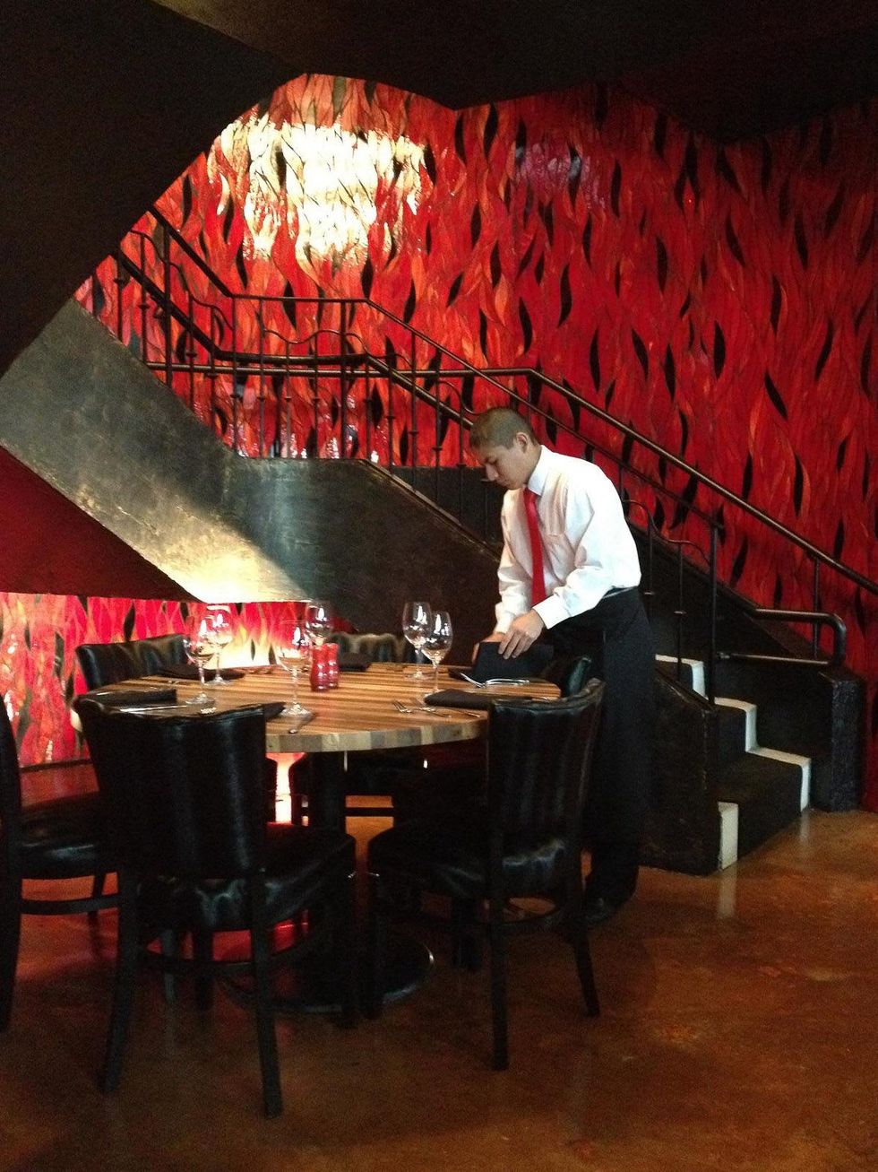 La Casa Del Caballo Houston waiter setting table