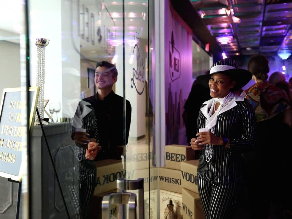 LaToya Williams greets guests at the surprise speakeasy during the Ars Lyrica "Roaring Twenties" Gala