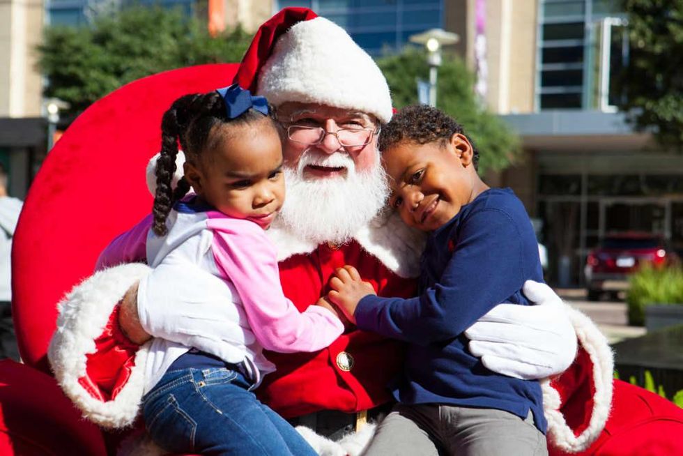 Little kids hugging Santa