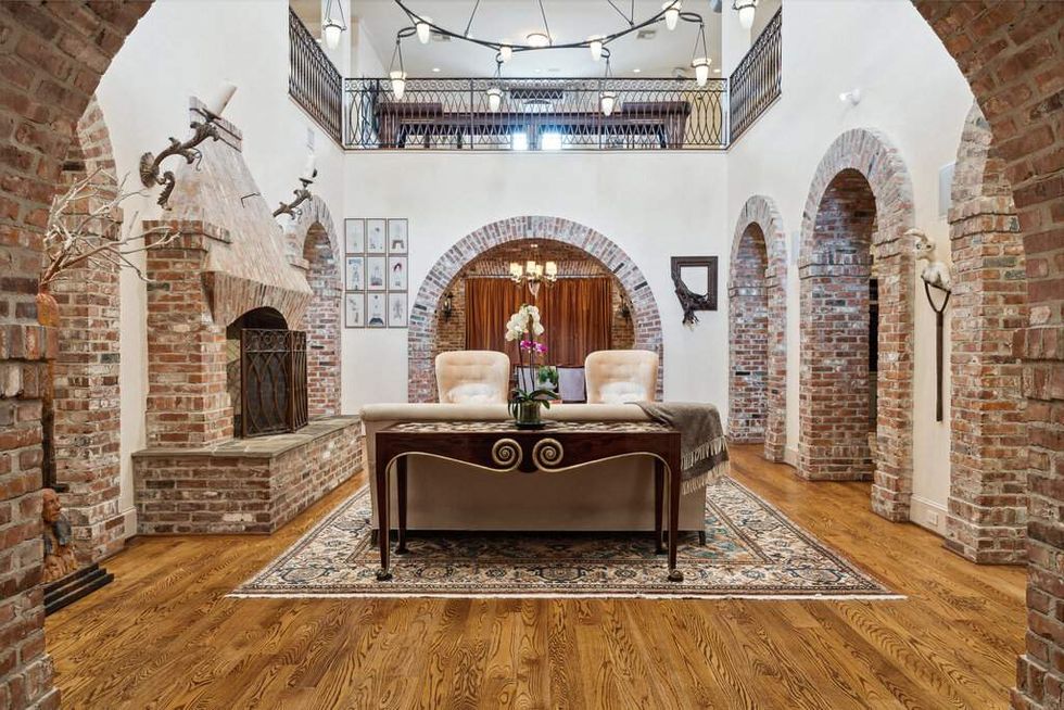 Living room with fireplace and chandelier of 3207 Sackett St.