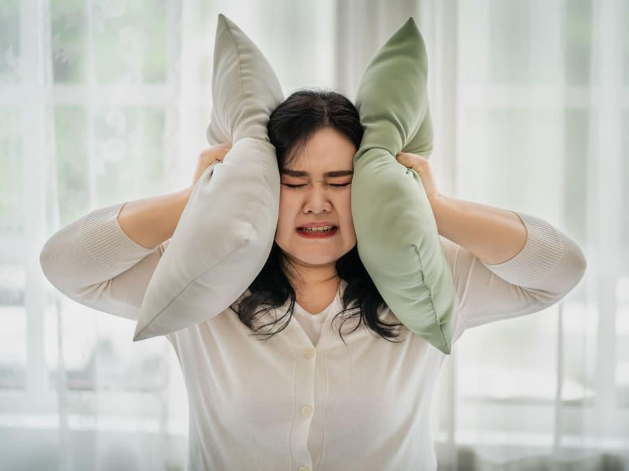 loud noise woman covering ears