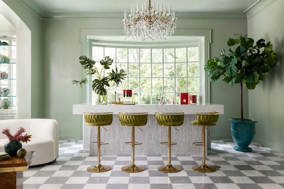 Lounge of 1069 Kirby Drive, showing a bar with barstools, chandelier and large window