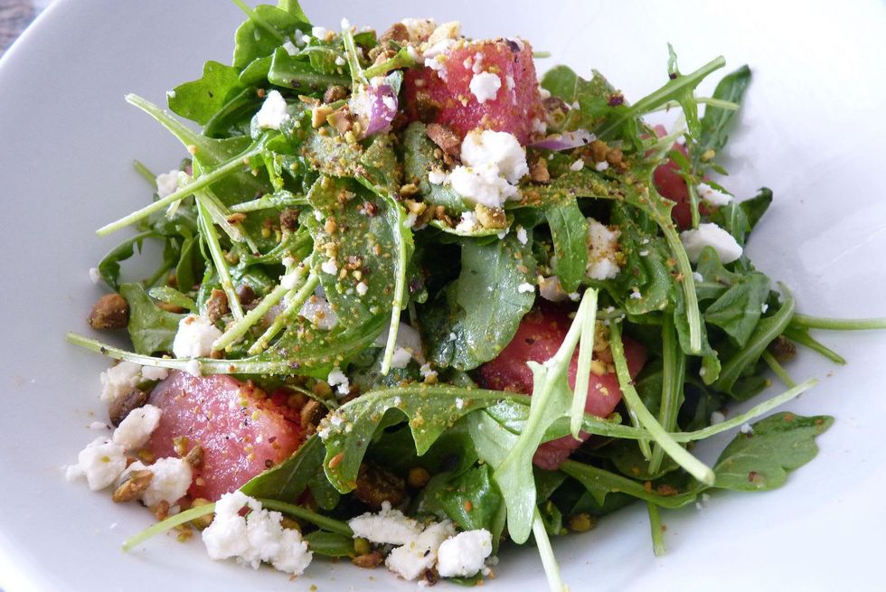 Lucille's watermelon salad with baby arugula, iced red onion, crushed pistachio and feta