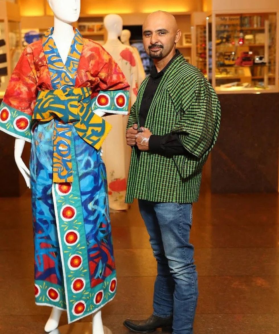 man standing next to mannequin