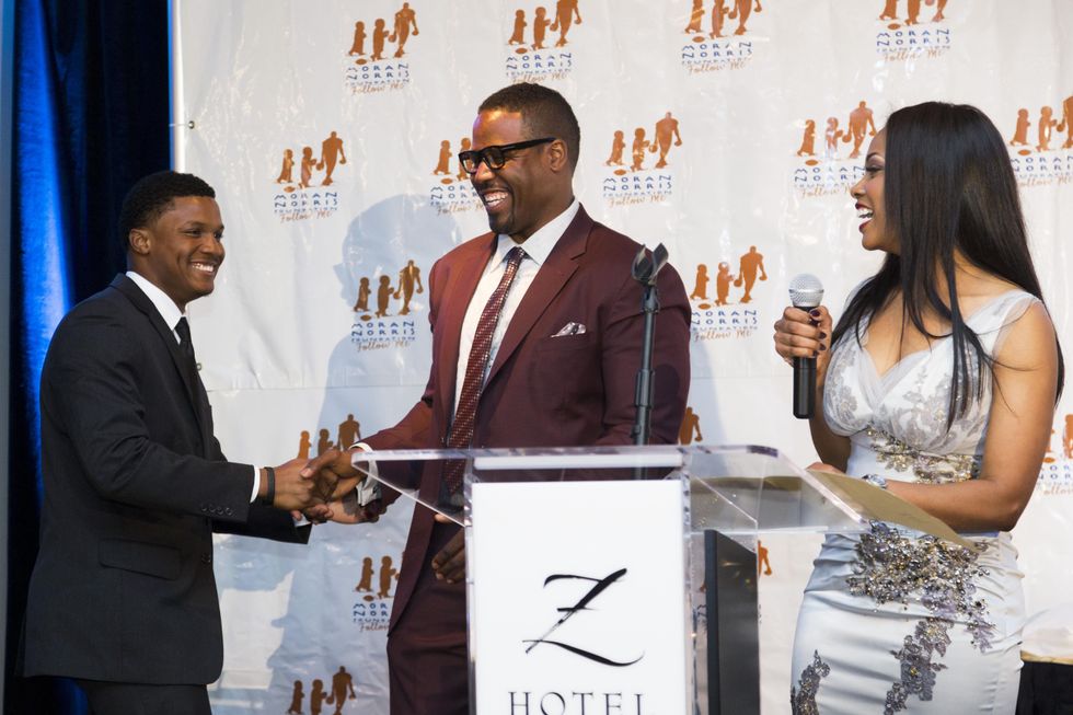 Moran and Tamara Norris congratulate Gabriel Byrd at the Moran Norris Foundation Gala