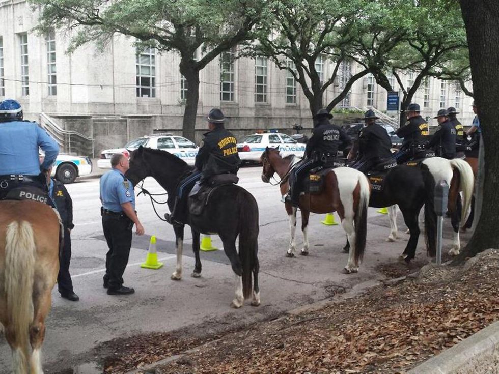 nearly every parking spot is taken by a police car or horse at Houston City Hall May 13, 2014