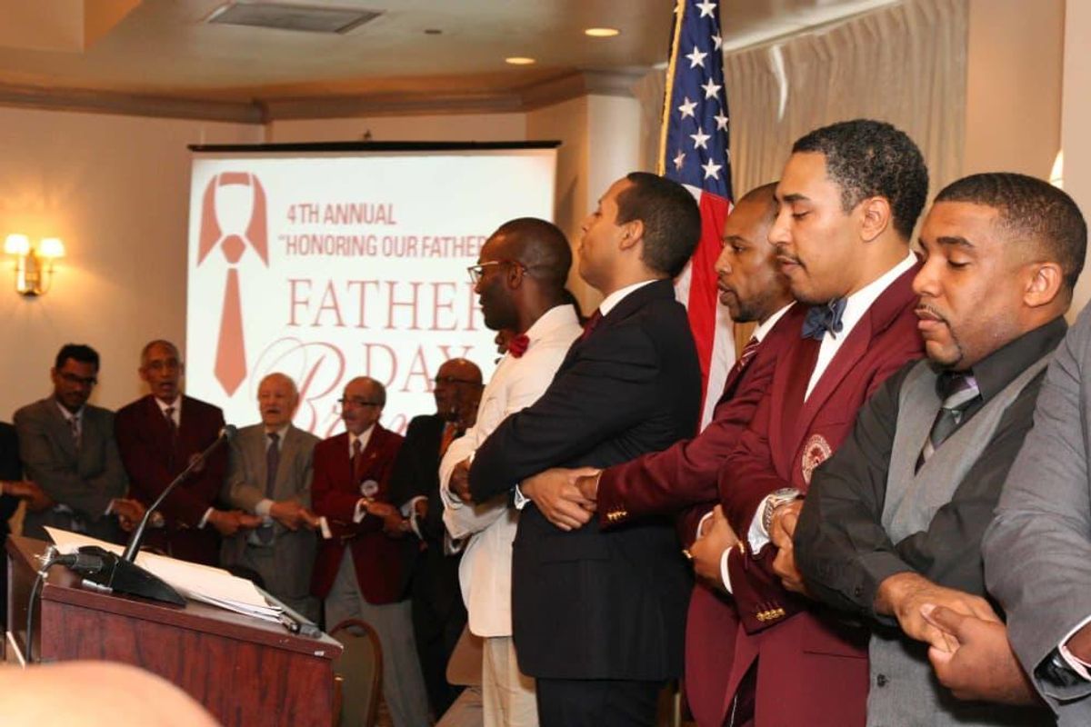 Morehouse alumns link arms while singing the college song. CultureMap