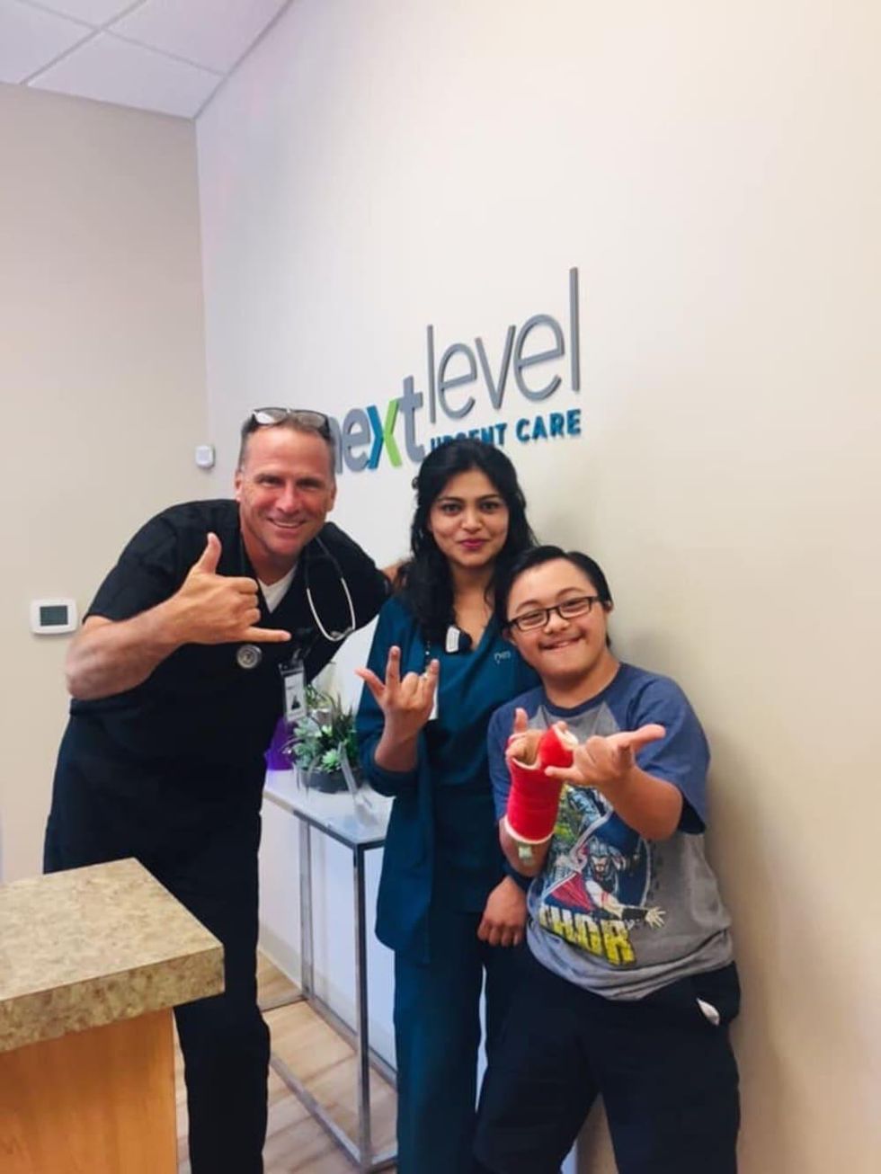 Next Level Urgent Care employees and patient
