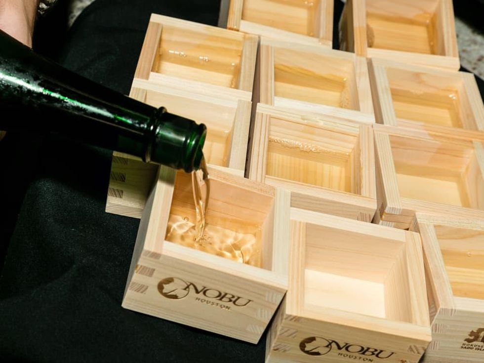 Nobu opening party pouring sake