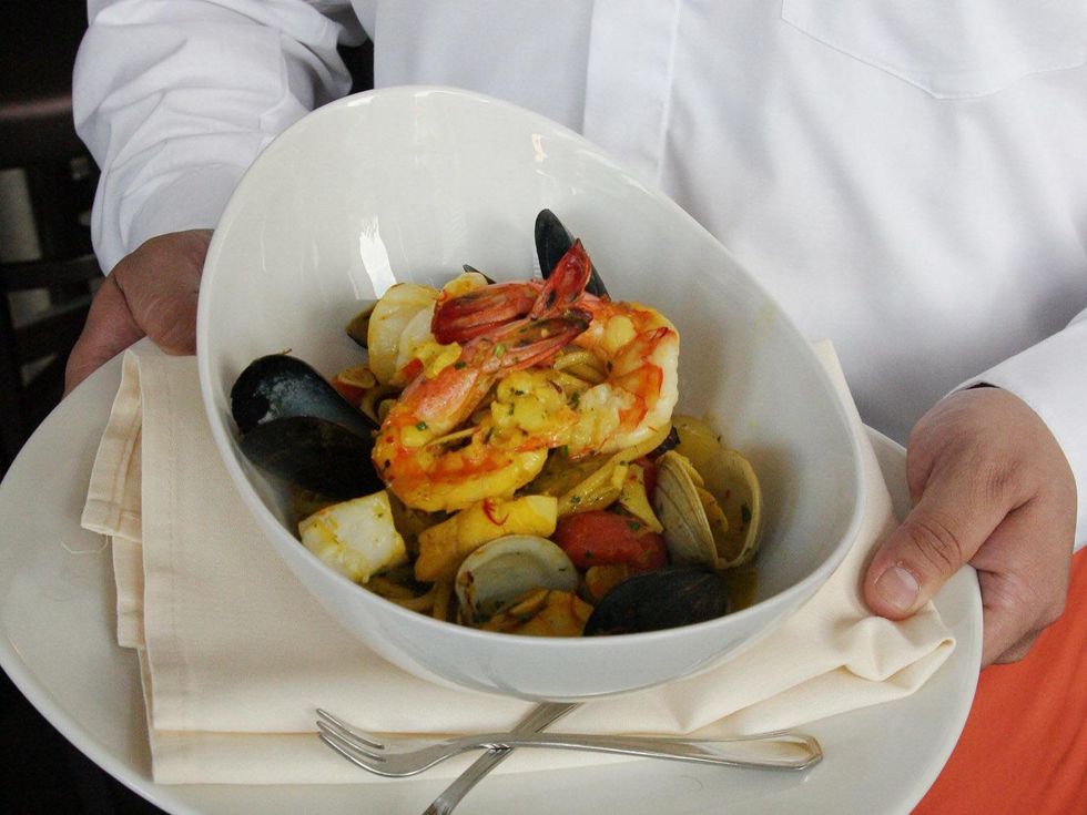 Osteria Mazzantini Chiatarra seared fruti de mare, saffron, heirloom tomatoes and pesto Genovese