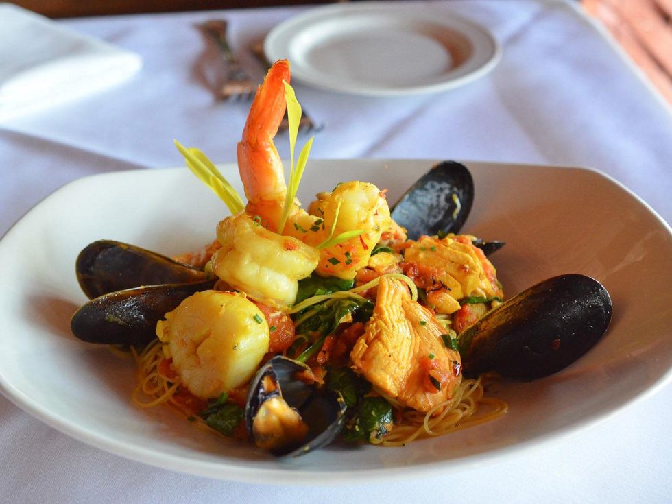 Osteria Mazzantini John Sheely sneak peek seafood pasta Angel Hair Pasta - Salmon,mussels, scallops, crawfish with roasted tomato, fresh basil in a saffron tomato broth