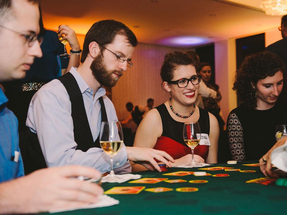 Party goers at the game table at Houston Symphony Young Professionals Backstage's Luck be a Lady event November 2013