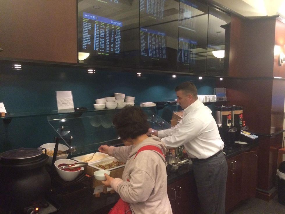 Passengers at United Club try the new food