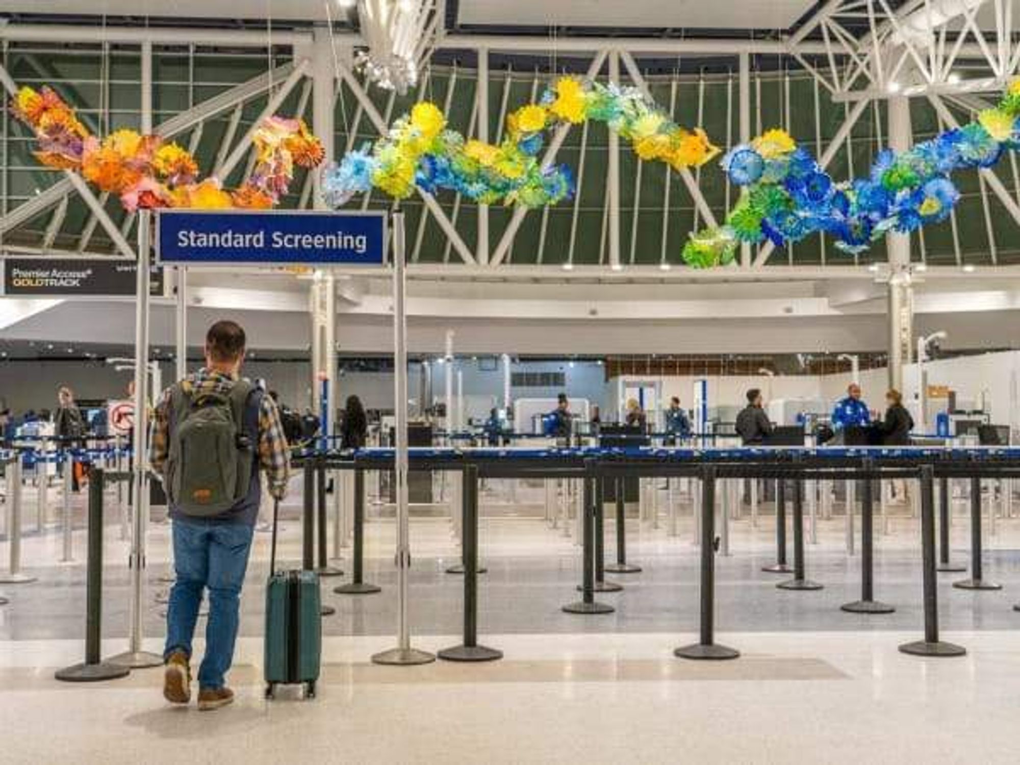 Passengers wait to recoeve boarding passes at Houston airport.