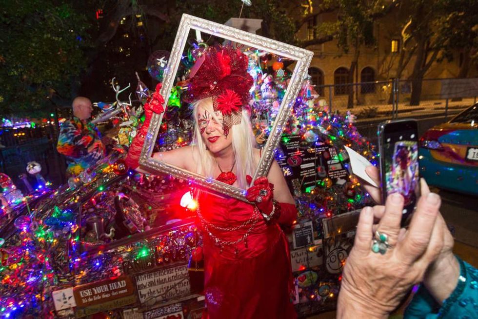 Patti Paulson of Minnesota, owner of the "Lipstick Car" has her picture taken in a frame during the Legendary Art Car Ball
