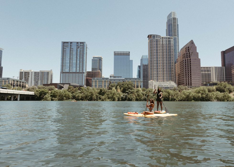 People stand-up paddleboarding in Austin