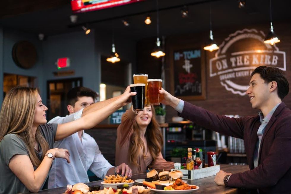 People toasting in a bar