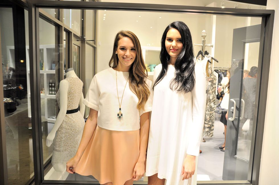 Phoenix Hamilton, left, with model Lauren Adams Atrium Ready To Wear at the What We Wear Where Mobile App party December 2013