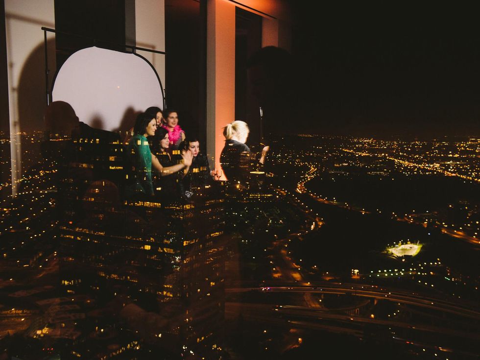 Photobooth in window reflection, sity-scape backdrop at Houston Symphony Young Professionals Backstage's Luck be a Lady event November 2013