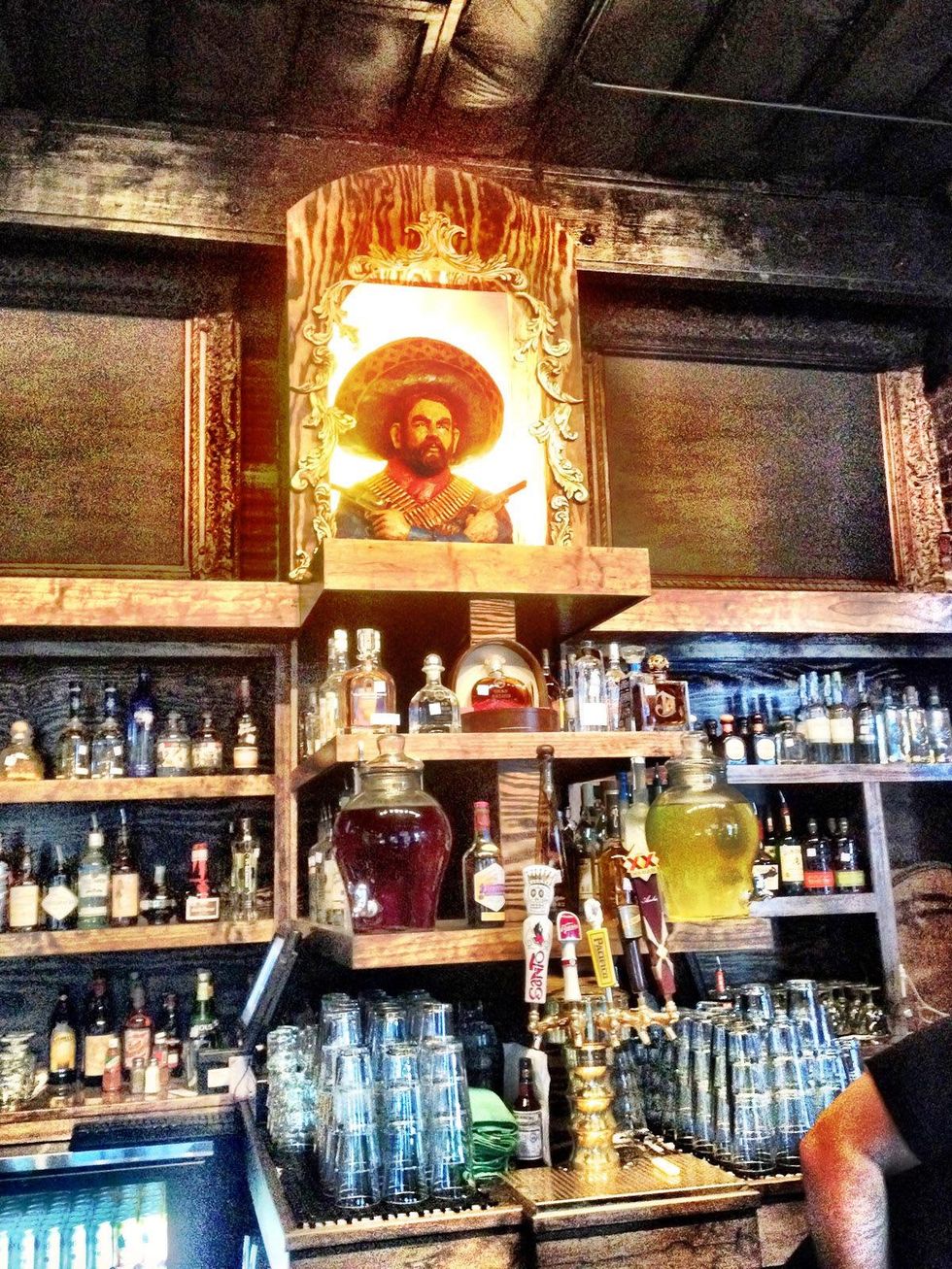 Pistolero's bar shrine with custom sculpture